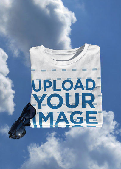Mockup of a Folded T-Shirt Featuring a Blue Sky Background m611
