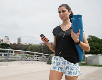 Mockup of a Woman Wearing Running Shorts on the Street