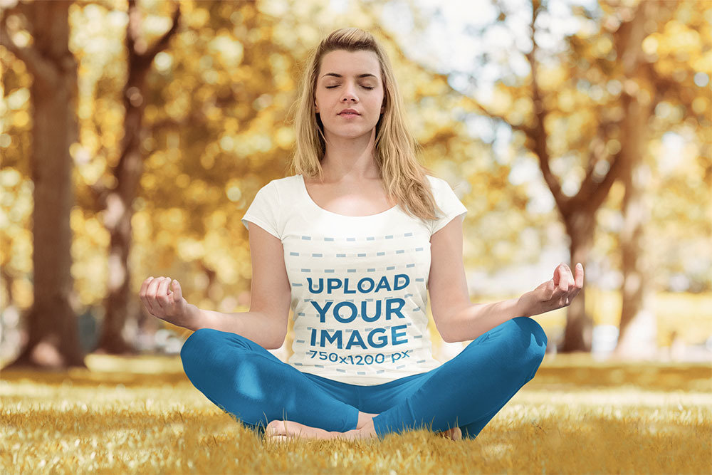 T-Shirt Mockup of a Woman Calmly Doing Yoga at a Park 