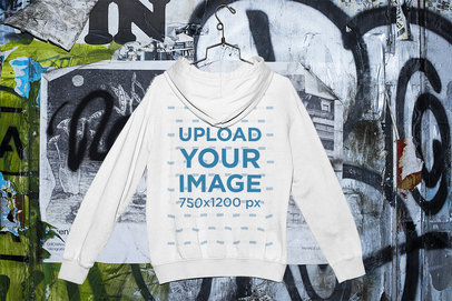 Mockup of a Hanged Hoodie by a Graffiti Wall