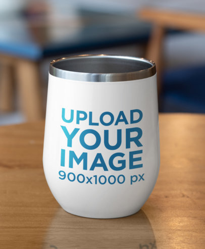 Mockup of a Wine Tumbler Placed on a Wooden Surface