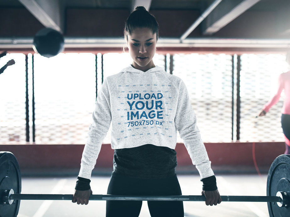 Mockup of a Woman Wearing a Heathered Crop Top Hoodie at the Gym