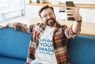 T-Shirt Mockup of a Man with Beard and Glasses Taking a Selfie 