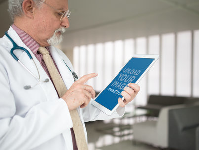 Mockup Featuring a Senior Doctor Using an iPad Pro in Portrait Position  12436a
