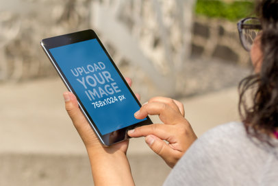 Mockup of a Woman with Glasses Using an iPad Mini 4130a