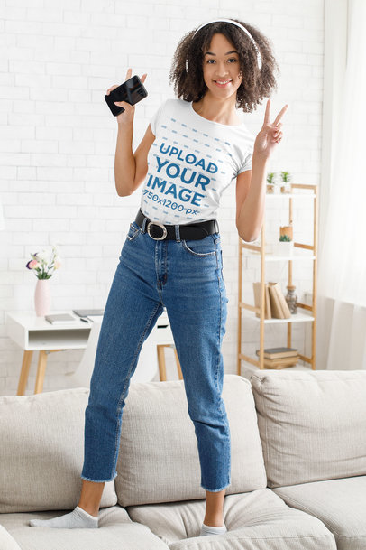 T-Shirt Mockup of a Happy Woman Dancing on the Couch