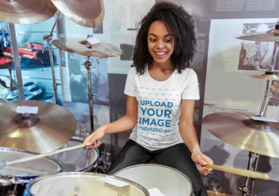 T-Shirt Mockup Featuring a Woman Playing Drums