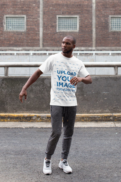 T-Shirt Mockup of a Man Wearing an Athleisure Look While Crossing the Street