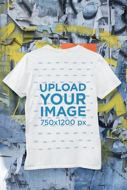 Mockup of a T-Shirt Hanging on a Wall with Old Posters and Graffiti