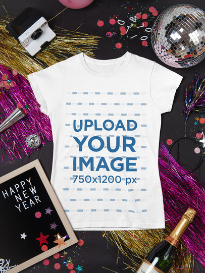 Mockup of a Woman's T-Shirt Lying with New Year's Celebration Items