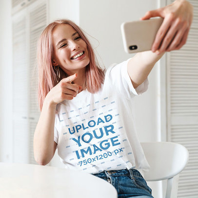 Unisex T-Shirt Mockup Featuring a Woman With Pink Hair Taking a Selfie 