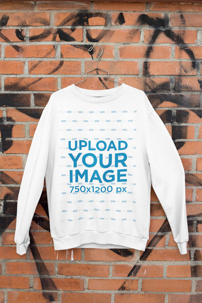 Mockup of a Sweatshirt Hanging Against a Brick Wall