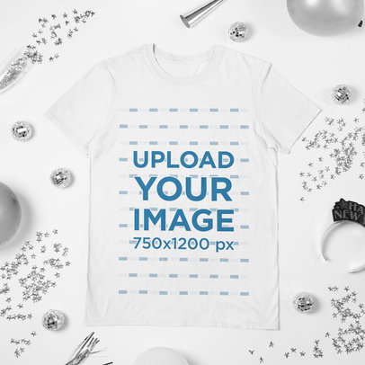 Mockup of a Round Neck T-Shirt Laid Flat on a New Year's Eve-Decorated Surface 