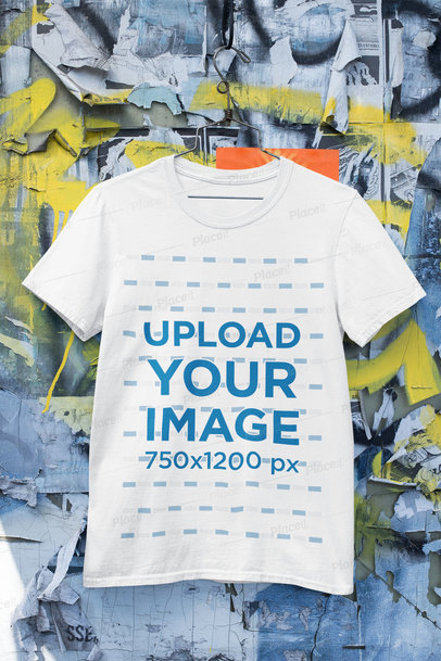 Mockup of a Round Neck T-Shirt Hanged Against an Urban Wall 