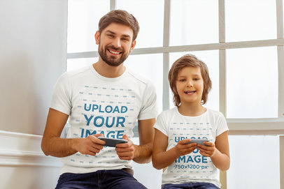 T-Shirt Mockup of a Man and His Son Playing Mobile Games 
