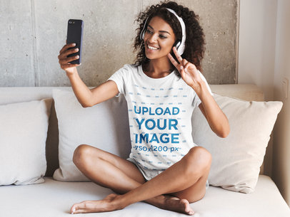 T-Shirt Mockup of a Happy Woman Making a Video Call at Home 