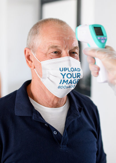 Face Mask Mockup of a Senior Man Getting His Temperature Checked 