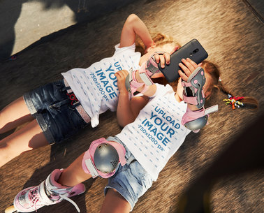 T-Shirt Mockup Featuring Two Sisters Taking a Selfie