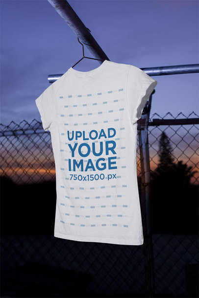 Mockup of a Women's T-Shirt Hanging Featuring the Sunset in the Background m487