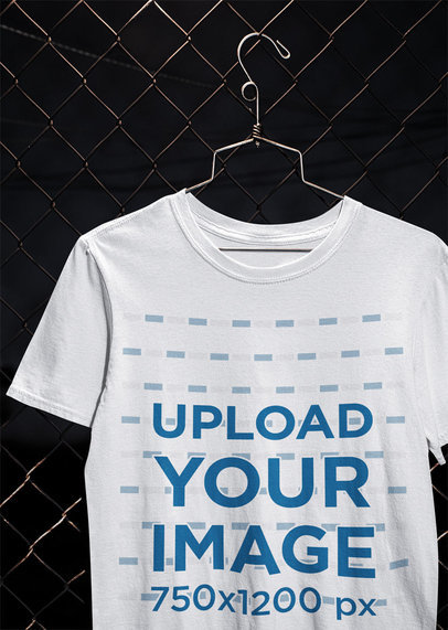 Mockup of a T-Shirt Hanging From a Chain-Link Fence m488