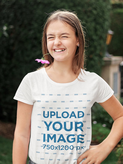 T-Shirt Mockup of a Teen Girl Playing with a Flower 