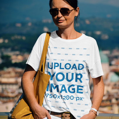 Mockup of a Woman Wearing a Loose T-Shirt While Traveling 