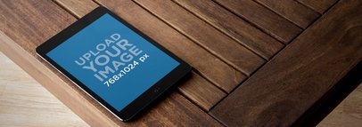 Black Portrait iPad Mini Over Wooden Table Wide