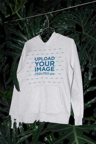 Mockup of a Pullover Hoodie Surrounded by Tropical Plants 