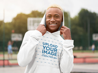 Mockup of a Smiling Man with Dyed Hair Wearing a Pullover Hoodie 