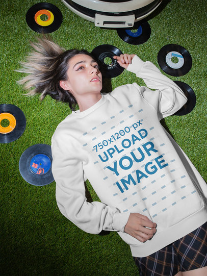 Sweatshirt Mockup of a Woman Lying on the Floor Surrounded by Music Albums m536
