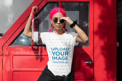 T-Shirt Mockup of a Pink-Haired Woman Posing by a Truck