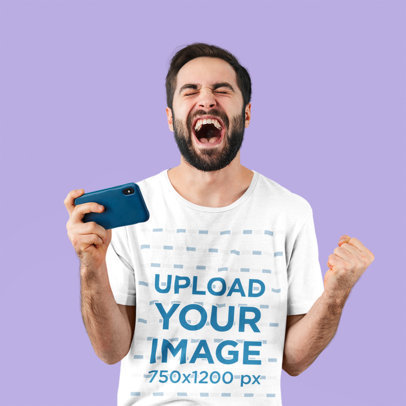 T-Shirt Mockup Featuring an Excited Man Holding a Phone