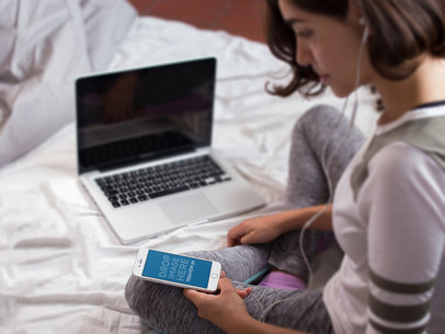 Girl Sitting on her Bed Listening to Music With Her iPhone 6 a14259