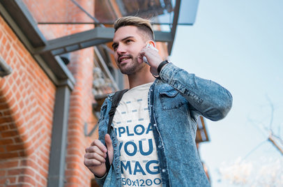 Tee Mockup of a Man with a Denim Garment Talking on the Phone