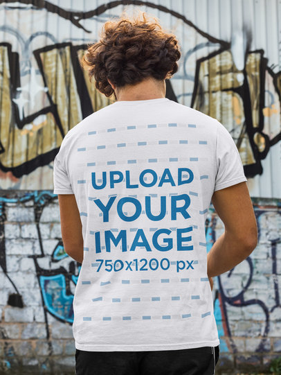 Back-View T-Shirt Mockup of a Man in Front of a Wall with Graffiti 