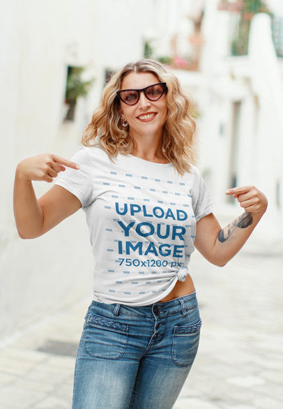 Mockup of a Smiling Woman Pointing at Her Tee 