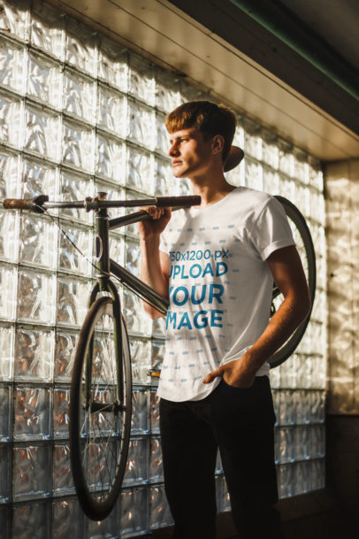 Tee Mockup of a Man Holding His Bicycle 