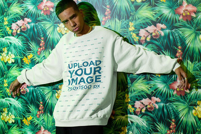 Sweatshirt Mockup of a Man Posing in Front of a Tropical-Themed Mural