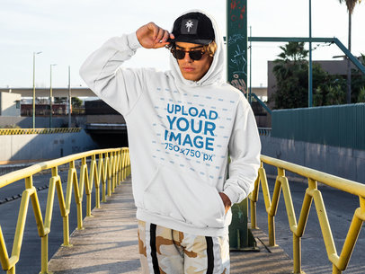 Mockup of a Man Wearing a Pullover Hoodie on the Street 
