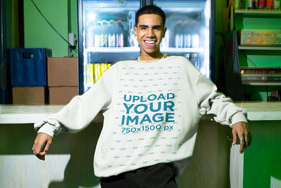 Mockup of a Man with an Oversized Sweatshirt Posing in a Bar