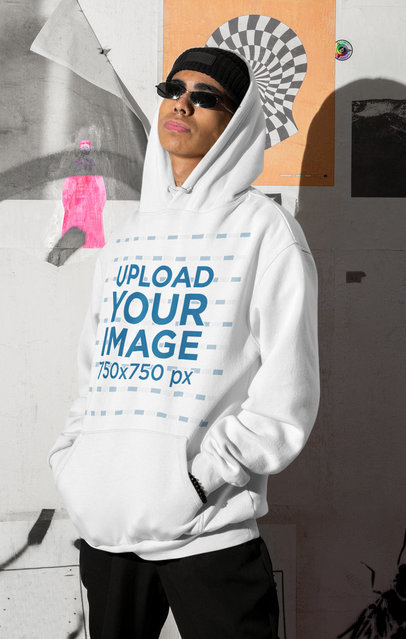 Pullover Hoodie Mockup of a Man with Sunglasses by an Urban Wall