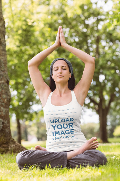 Tank Top Mockup of a Calm Woman Doing Yoga at a Park