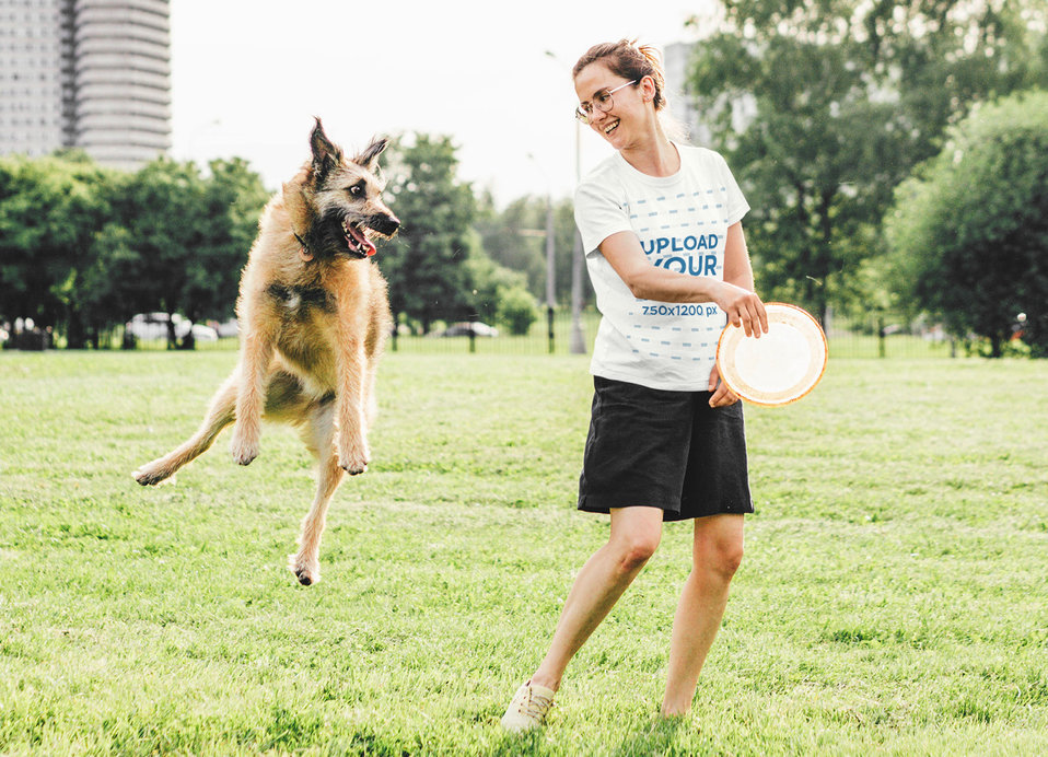 T-Shirt Mockup of a Happy Woman Playing with Her Dog at a Park