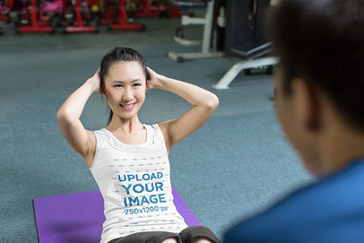 Tank Top Mockup of a Woman Doing Abs with a Trainer