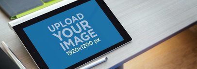 Wide Mockup of a Lenovo Yoga in Landscape Position over a Workstation