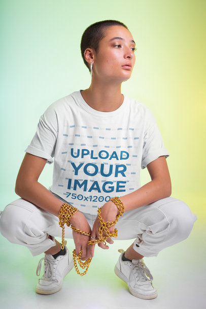 T-Shirt Mockup of a Woman Holding a Golden Chain in Her Hands