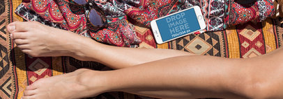 Mockup of a White iPhone 6 Lying Near a Woman Legs in Landscape Position 14293wide