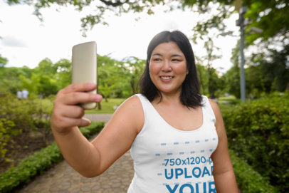 Tank Top Mockup of a Woman Taking a Selfie at a Park