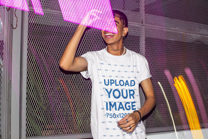 T-Shirt Mockup Featuring a Man Surrounded by Neon Lights m583