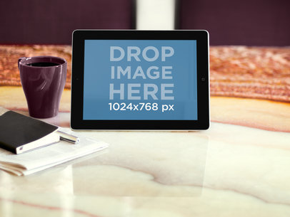 Mockup of an iPad in Landscape Position Placed on a Marble Table